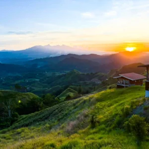 Breathtaking mountain sunrise overlooking rolling green
